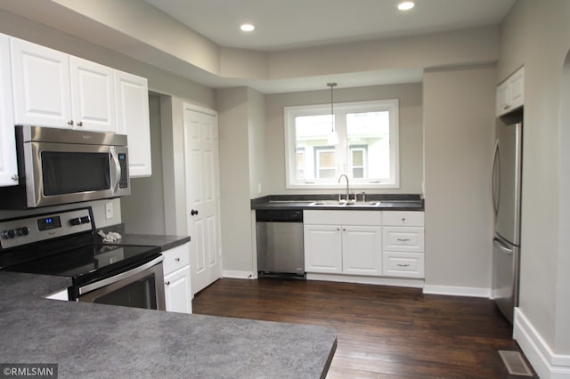 209 Cleveland St SW, Silver Lake, MN 55381 - kitchen with appliances with stainless steel finishes, dark wood finished floors, white cabinets, and recessed lighting