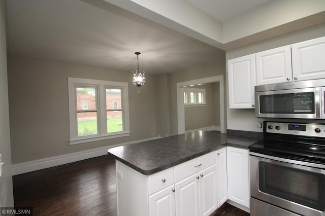 209 Cleveland St SW, Silver Lake, MN 55381 - kitchen featuring appliances with stainless steel finishes, a peninsula, dark wood-type flooring, white cabinets, and dark countertops