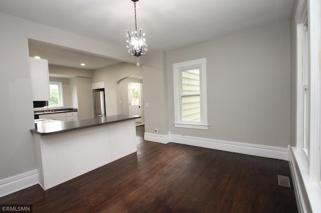 209 Cleveland St SW, Silver Lake, MN 55381 - kitchen featuring freestanding refrigerator, arched walkways, dark countertops, dark wood finished floors, and recessed lighting