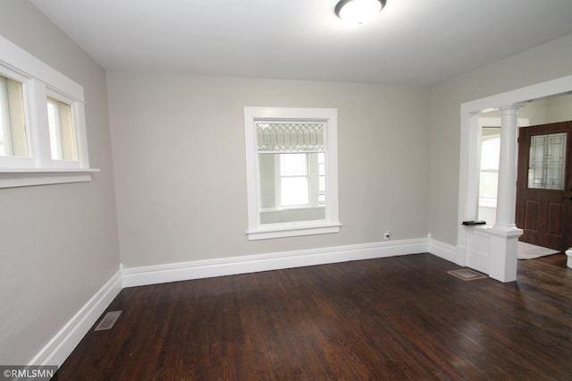 209 Cleveland St SW, Silver Lake, MN 55381 - unfurnished room with ornate columns and dark wood finished floors