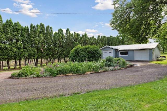 20240 Saint Croix Trl N, Scandia, MN 55073 - view of front of house featuring an outdoor structure, a metal roof, driveway, and a garage