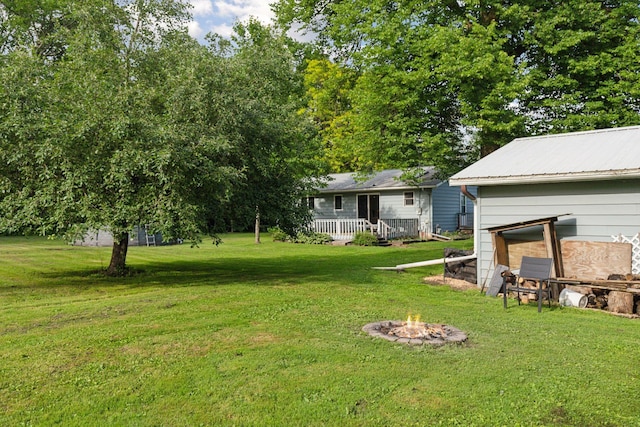 20240 Saint Croix Trl N, Scandia, MN 55073 - view of grassy yard with a fire pit and a wooden deck