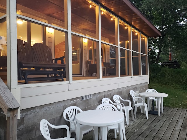20758 Pike Ave, Aitkin, MN 56431 - deck featuring outdoor dining area and a sunroom