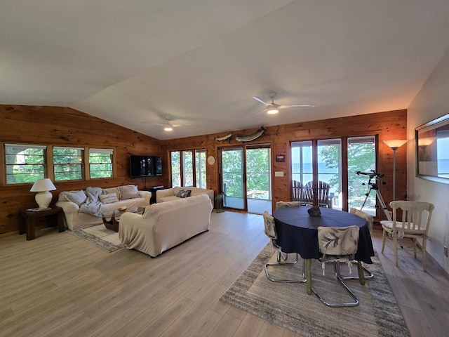20758 Pike Ave, Aitkin, MN 56431 - living room featuring wooden walls, ceiling fan, lofted ceiling, and light wood-style flooring