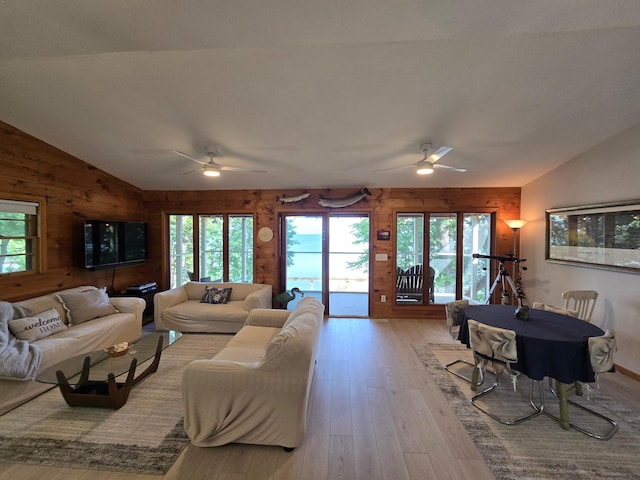20758 Pike Ave, Aitkin, MN 56431 - living area featuring vaulted ceiling, ceiling fan, wood walls, and hardwood / wood-style flooring