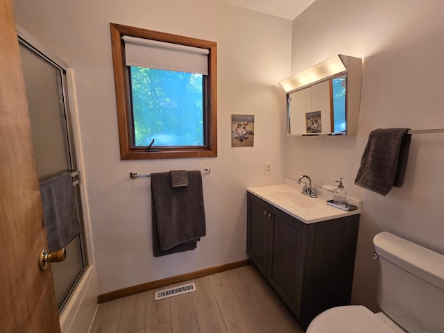 20758 Pike Ave, Aitkin, MN 56431 - bathroom with vanity, wood finished floors, and enclosed tub / shower combo