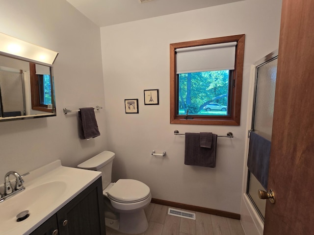 20758 Pike Ave, Aitkin, MN 56431 - bathroom with vanity, combined bath / shower with glass door, and wood finished floors