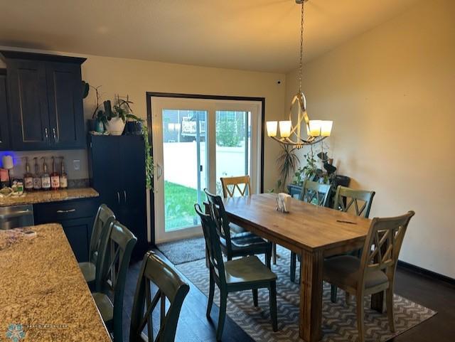 959 29th Ave W, West Fargo, ND 58078 - dining area with dark wood finished floors, a dry bar, and a chandelier