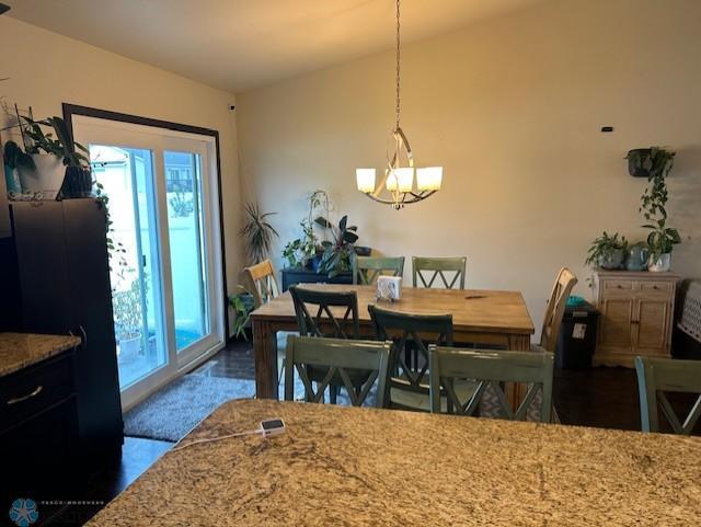 959 29th Ave W, West Fargo, ND 58078 - dining area featuring a chandelier and healthy amount of natural light