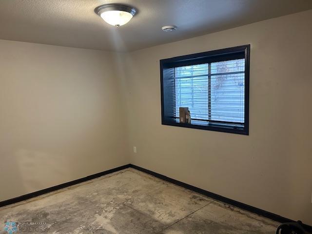 959 29th Ave W, West Fargo, ND 58078 - empty room with unfinished concrete floors and a smoke detector