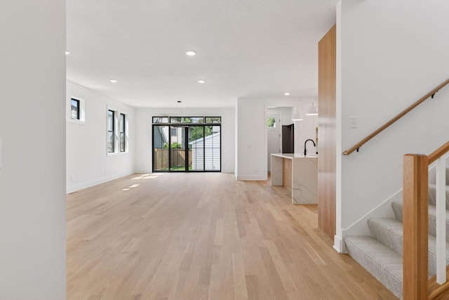 2084 Palace Ave, Saint Paul, MN 55105 - unfurnished living room featuring light wood-style floors, recessed lighting, and stairway