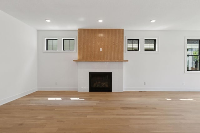2084 Palace Ave, Saint Paul, MN 55105 - unfurnished living room featuring a fireplace, light wood-style floors, and recessed lighting