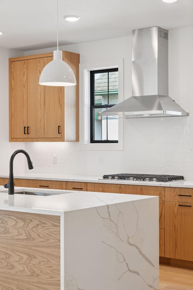 2084 Palace Ave, Saint Paul, MN 55105 - kitchen featuring island range hood, stainless steel gas cooktop, backsplash, light stone countertops, and pendant lighting