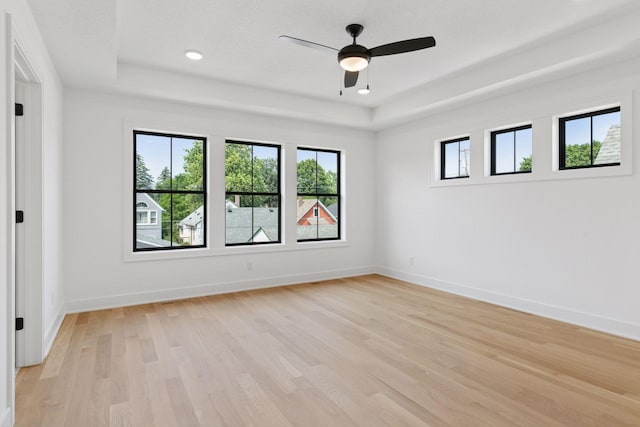 2084 Palace Ave, Saint Paul, MN 55105 - unfurnished room featuring a tray ceiling, light wood-type flooring, a ceiling fan, and recessed lighting