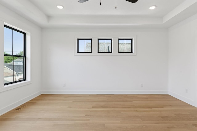 2084 Palace Ave, Saint Paul, MN 55105 - spare room with a tray ceiling, ceiling fan, light wood-type flooring, and recessed lighting