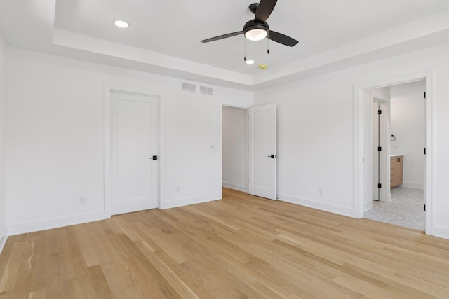 2084 Palace Ave, Saint Paul, MN 55105 - unfurnished bedroom with a raised ceiling, light wood finished floors, ensuite bath, and recessed lighting