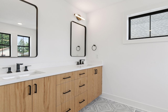 2084 Palace Ave, Saint Paul, MN 55105 - bathroom featuring double vanity and baseboards