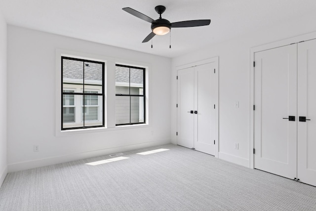2084 Palace Ave, Saint Paul, MN 55105 - unfurnished bedroom with two closets, carpet flooring, and ceiling fan