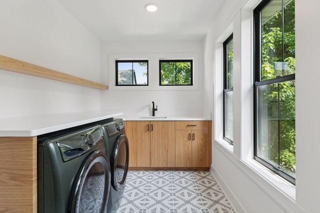 2084 Palace Ave, Saint Paul, MN 55105 - laundry room featuring washing machine and clothes dryer, healthy amount of natural light, cabinet space, and bar with sink