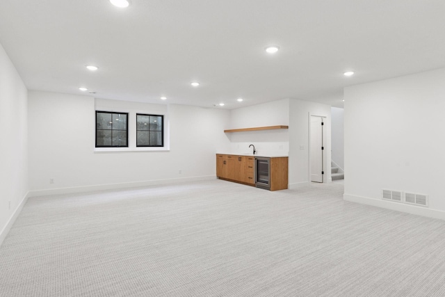 2084 Palace Ave, Saint Paul, MN 55105 - unfurnished living room featuring wet bar, recessed lighting, light carpet, beverage cooler, and stairs
