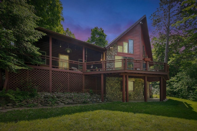 62405 Delta Lake Rd, Delta, WI 54847 - rear view of house with a yard, a deck, stone siding, and faux log siding