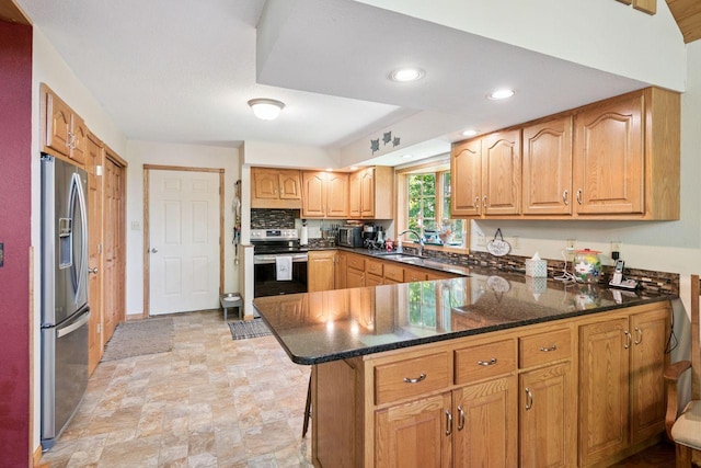62405 Delta Lake Rd, Delta, WI 54847 - kitchen with appliances with stainless steel finishes, a peninsula, stone finish floors, recessed lighting, and dark stone countertops