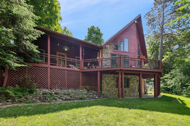 62405 Delta Lake Rd, Delta, WI 54847 - rear view of house with a yard, stone siding, a deck, and faux log siding