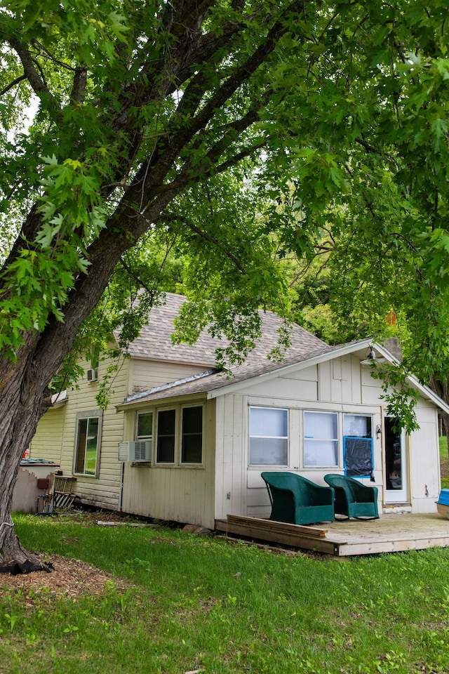 17700 78th St SW, Cokato, MN 55321 - back of property featuring roof with shingles, a lawn, and cooling unit