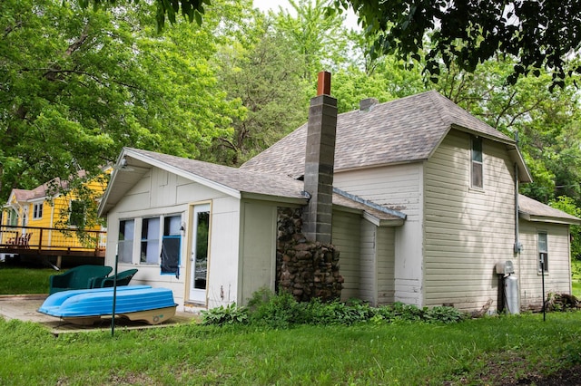 17700 78th St SW, Cokato, MN 55321 - back of property featuring a shingled roof, a chimney, a wooden deck, and a yard