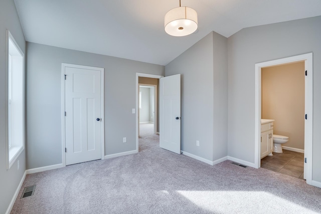 17360 62nd St NE, Otsego, MN 55330 - unfurnished bedroom with lofted ceiling, carpet flooring, multiple windows, and ensuite bathroom