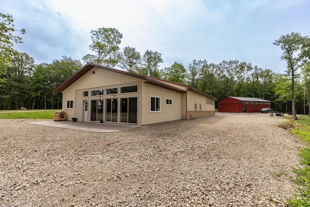 9005 80th Ave SE, Orion Twp, MN 55923 - back of house featuring gravel driveway and a patio area
