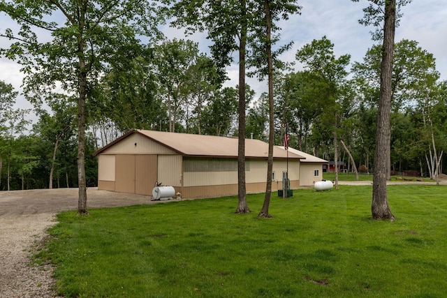 9005 80th Ave SE, Orion Twp, MN 55923 - view of property exterior featuring a lawn, view of scattered trees, and an outbuilding