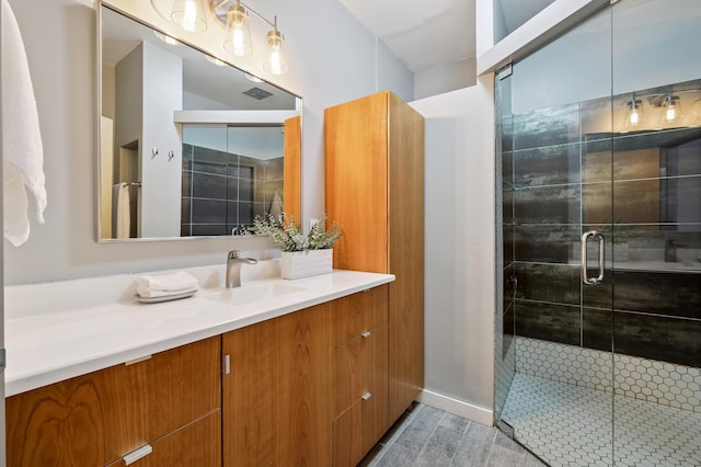 918 3rd St N Unit 210, Minneapolis, MN 55401 - bathroom with vanity, a stall shower, and wood finished floors