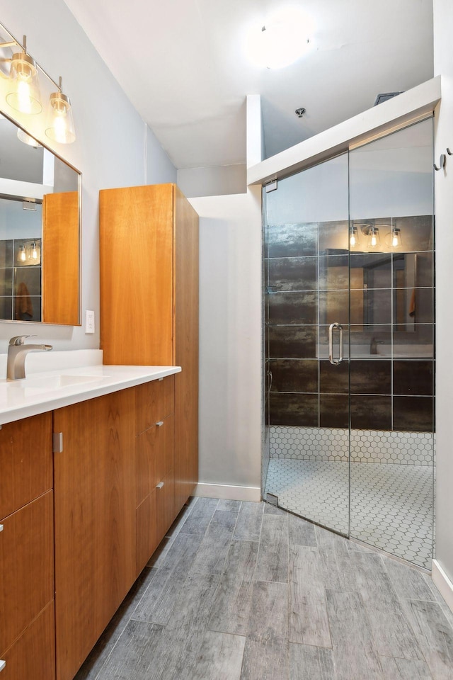 918 3rd St N Unit 210, Minneapolis, MN 55401 - bathroom with vanity, wood finished floors, and a shower stall