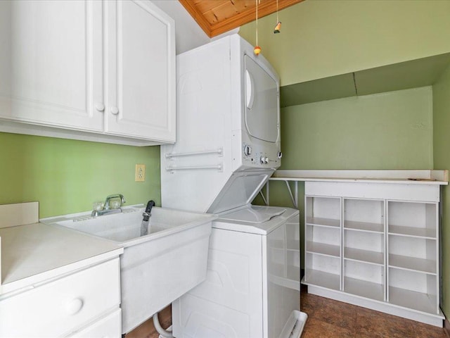 33277 308th Ln, Aitkin, MN 56431 - laundry room featuring stacked washer and clothes dryer and cabinet space