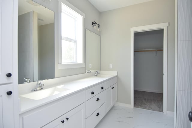 21705 Willys St NE, East Bethel, MN 55011 - bathroom with double vanity, marble finish floors, and a walk in closet