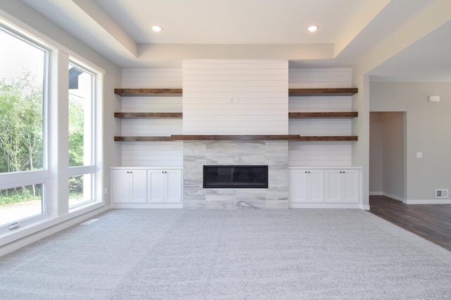 21705 Willys St NE, East Bethel, MN 55011 - unfurnished living room featuring carpet flooring, a tile fireplace, recessed lighting, and a raised ceiling