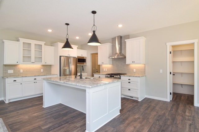 21705 Willys St NE, East Bethel, MN 55011 - kitchen with appliances with stainless steel finishes, wall chimney exhaust hood, decorative backsplash, white cabinetry, and recessed lighting