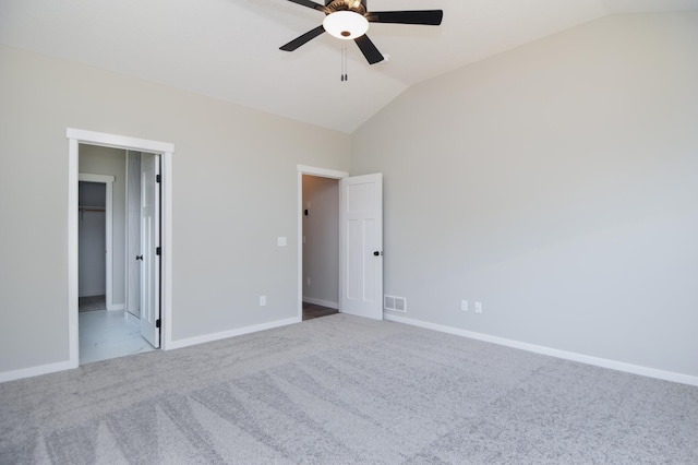 21705 Willys St NE, East Bethel, MN 55011 - unfurnished bedroom featuring vaulted ceiling, carpet flooring, a ceiling fan, and a spacious closet