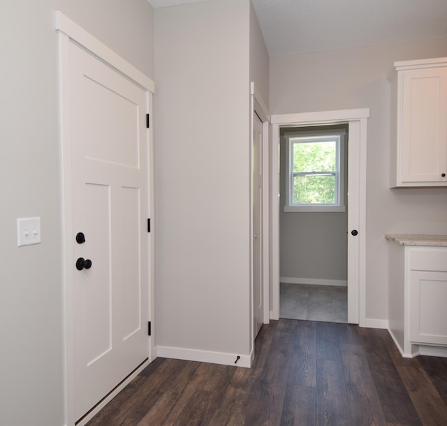 21705 Willys St NE, East Bethel, MN 55011 - laundry room featuring dark wood-style flooring and baseboards