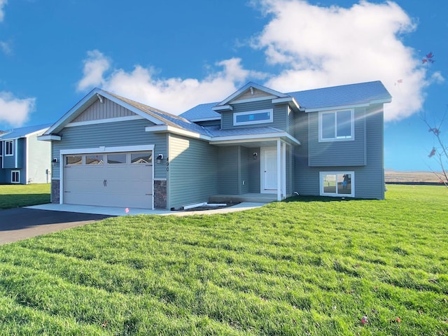 1180 Stonebrooke Dr, Albany, MN 56307 - tri-level home with a garage, a front lawn, driveway, and stone siding