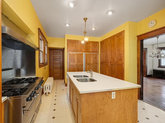 2320 Humboldt Ave S, Minneapolis, MN 55405 - kitchen with radiator, brown cabinets, light countertops, hanging light fixtures, and an island with sink