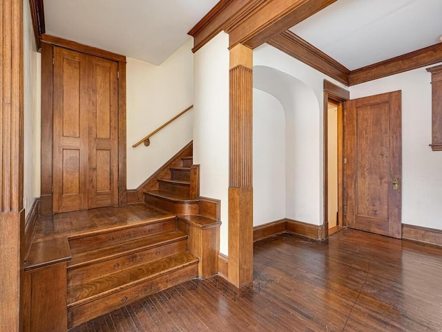 2320 Humboldt Ave S, Minneapolis, MN 55405 - stairs featuring wood finished floors, arched walkways, and crown molding