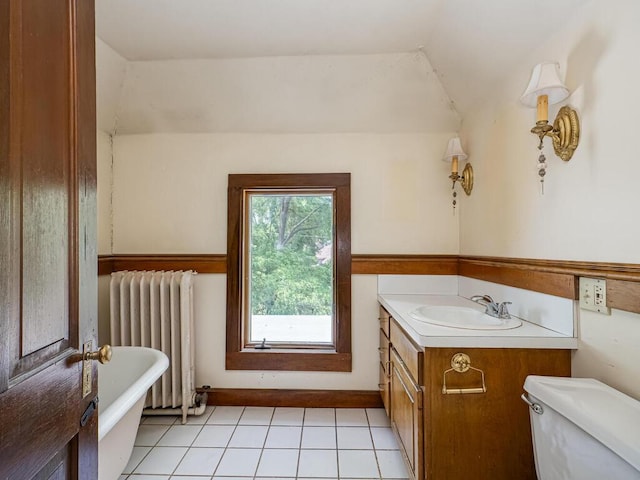 2320 Humboldt Ave S, Minneapolis, MN 55405 - full bathroom featuring radiator, a soaking tub, vanity, tile patterned floors, and lofted ceiling