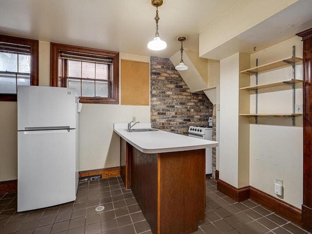 2320 Humboldt Ave S, Minneapolis, MN 55405 - kitchen with freestanding refrigerator, a peninsula, dark tile patterned floors, and light countertops