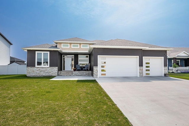 3664 Valley View Dr S, Fargo, ND 58104 - prairie-style house with an attached garage, stone siding, and driveway