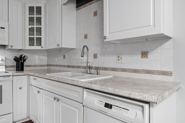 2485 Canabury Dr Unit 112, Little Canada, MN 55117 - kitchen featuring white appliances, white cabinetry, backsplash, and light countertops
