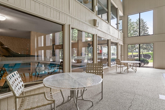 2485 Canabury Dr Unit 112, Little Canada, MN 55117 - dining space featuring a towering ceiling and carpet floors