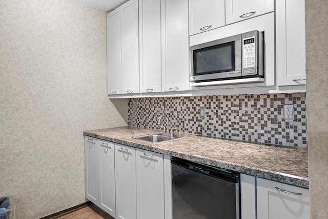 2485 Canabury Dr Unit 112, Little Canada, MN 55117 - kitchen featuring dishwashing machine, stainless steel microwave, tasteful backsplash, and white cabinets