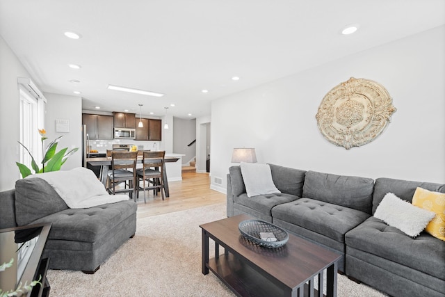 7237 Ada Dr, Lino Lakes, MN 55038 - living area with recessed lighting, stairs, and light carpet